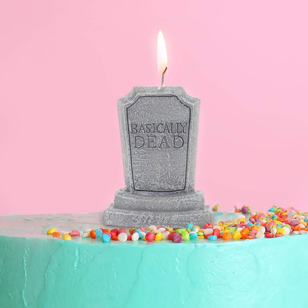 Graveyard tombstone candle with 'Basically Dead' text on a pink background