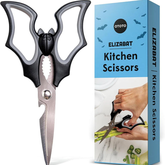 Kitchen scissors shaped like a bat with black and gray handles next to their packaging box on a white background
