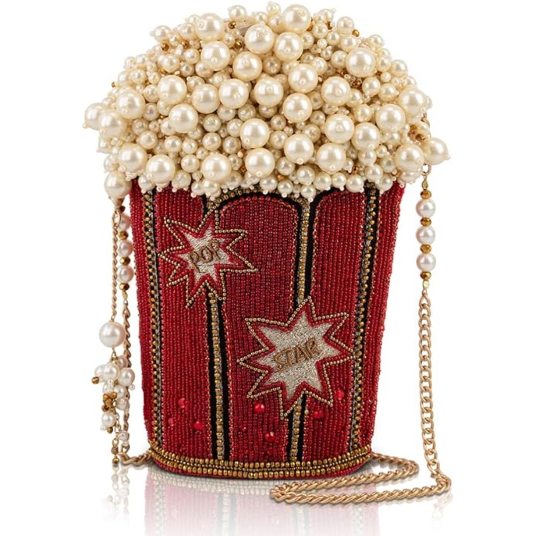 A handbag made with pearls and red beadwork shaped like a bucket of popcorn.