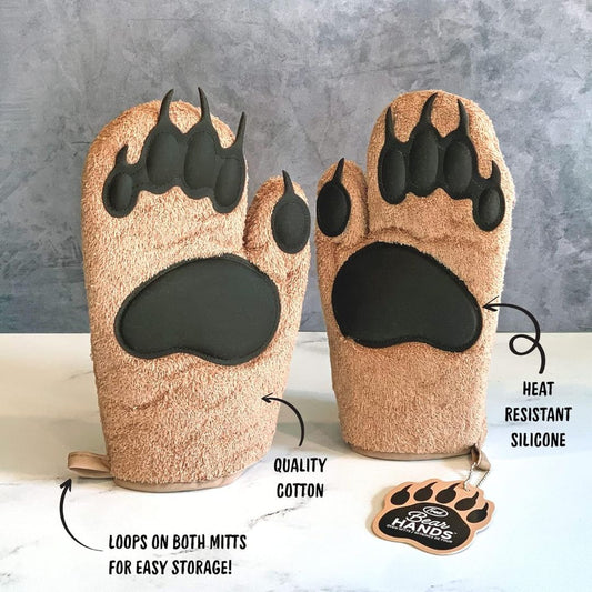 Pair of bear paw-shaped oven mitts with text highlighting features on a gray background.
