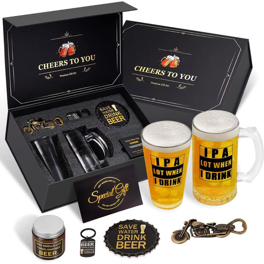 A beer-themed gift set displayed on a white background, including two frosted beer steins with 'IPA LOT WHEN I DRINK' text, a black presentation box with 'CHEERS TO YOU' printed inside, a bottle opener, a small jar, a coaster, and a keychain.