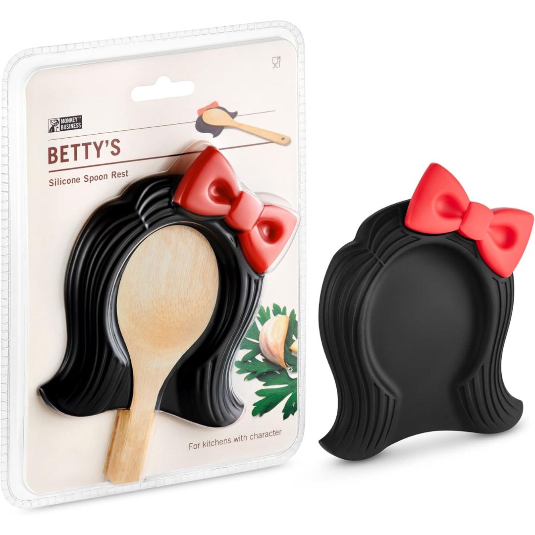Silicone spoon rest with black hair and red bow called Betty's with packaging
