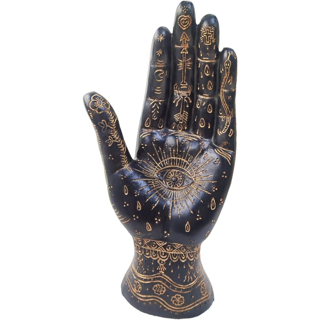 A black and gold decorative palmisty hand-shaped sculpture  with intricate gold occult and spiritual designs, including an eye of providence on the palm, set against a plain white background.