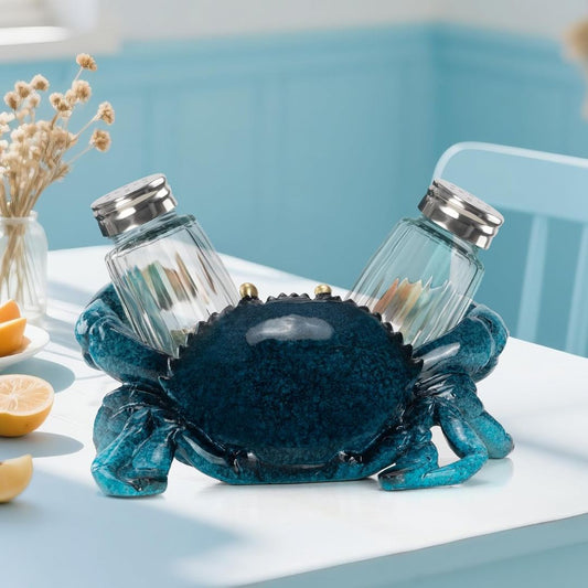 Blue crab-shaped salt and pepper shaker holder set on a table with a light blue background.