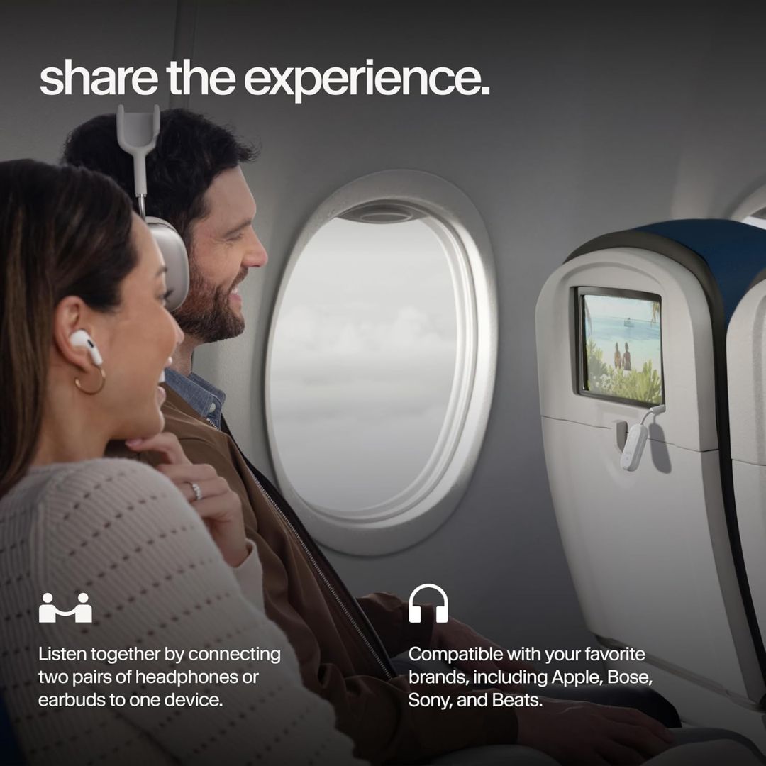 A man and woman watching a movie on an airplane while using a bluetooth headphone jack adapter