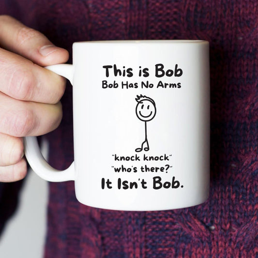 A hand holding a coffee cup with text 'This is Bob, Bob has no arms, knock knock who's there, it isn't Bob'