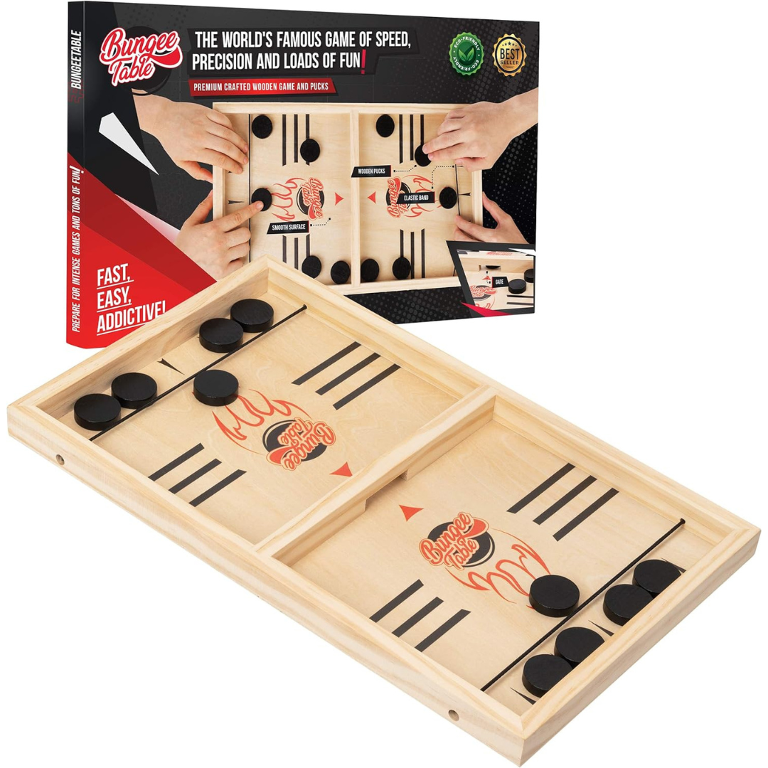 Wooden tabletop sling puck game with elastic launchers and black pucks