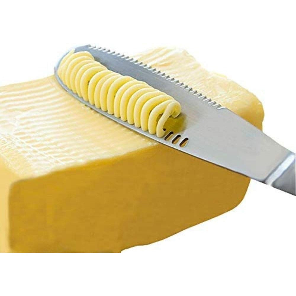 A butter spreader knife being used to curl butter.