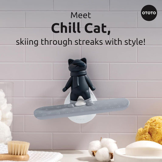 A shower squeegee shaped like a cat on a snowboard with text that reads, 'Meet chill cat, skiing through streaks with style'