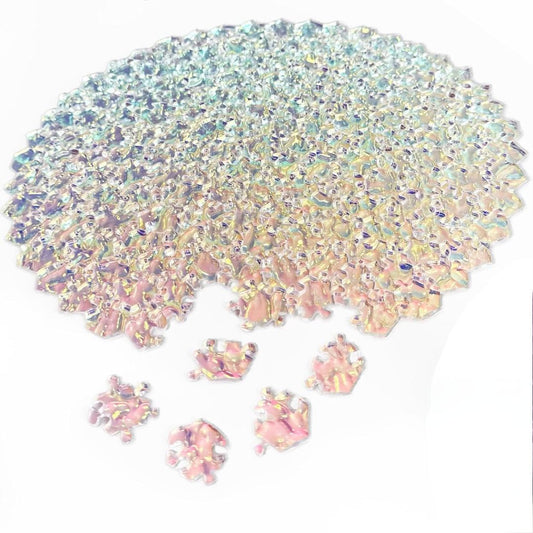 An impossible jigsaw puzzle made form clear pieces with a few puzzle pieces scattered on a white background