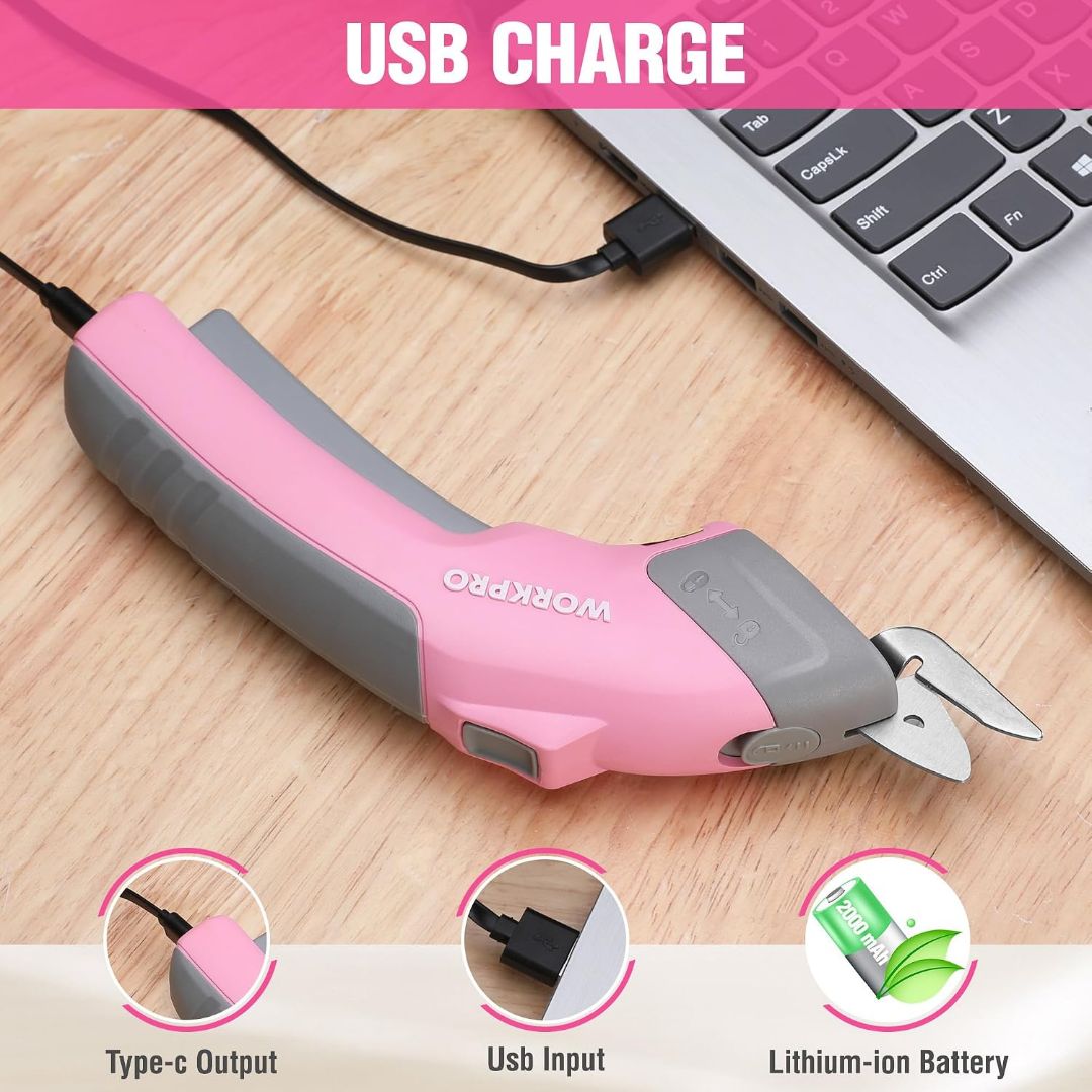 Pink WORKPRO rechargeable electric scissors with dual blades charging by USB-C from a laptop