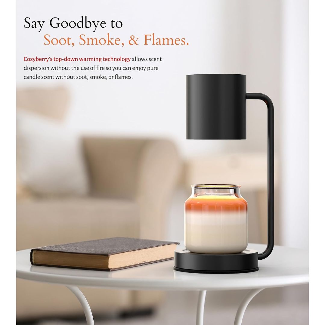 A Cozyberry dimmable candle warmer lamp with a lit candle on a table next to a book.