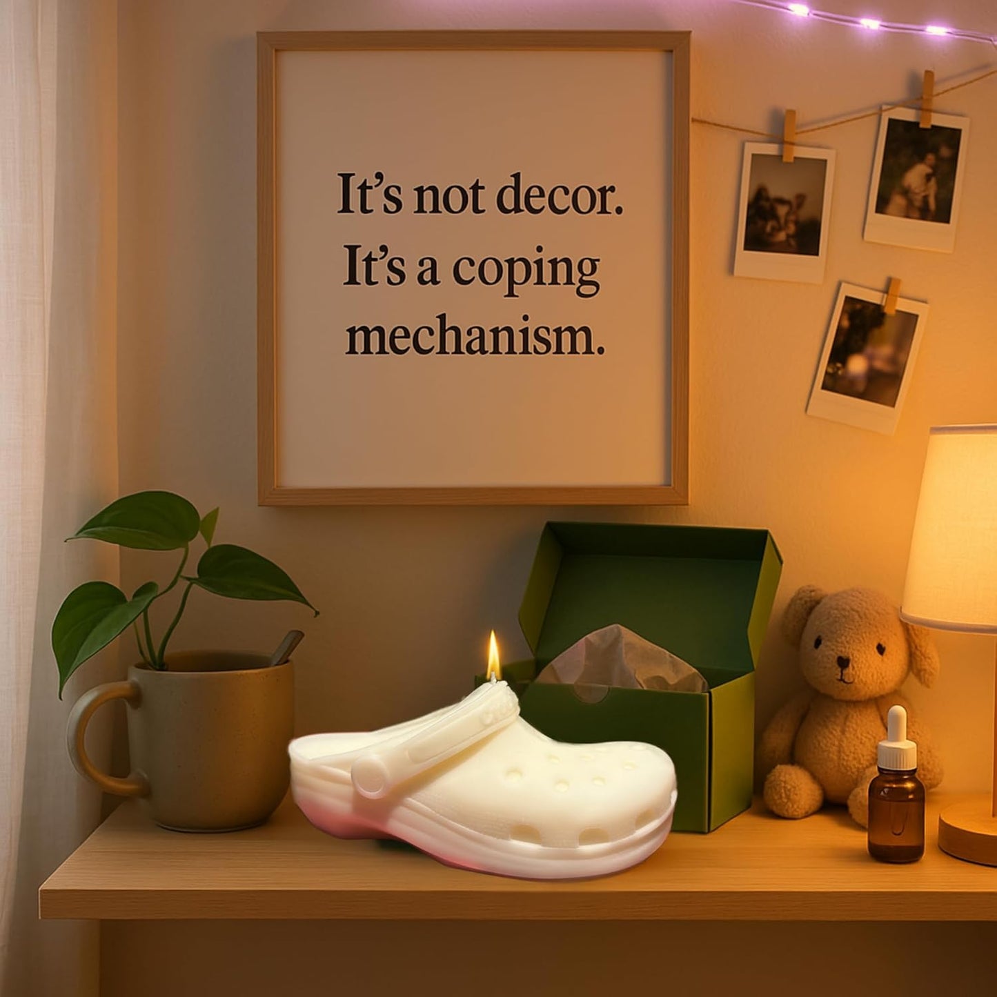 Candle shaped like a white croc shoe on a shelf with a framed quote, plant, mug, and teddy bear.