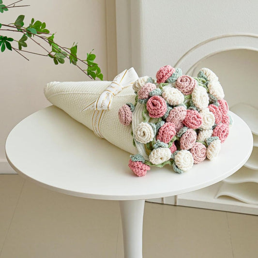 Crochet flower bouquet blanket wrapped like a bouquet with pink and white roses and green leaves