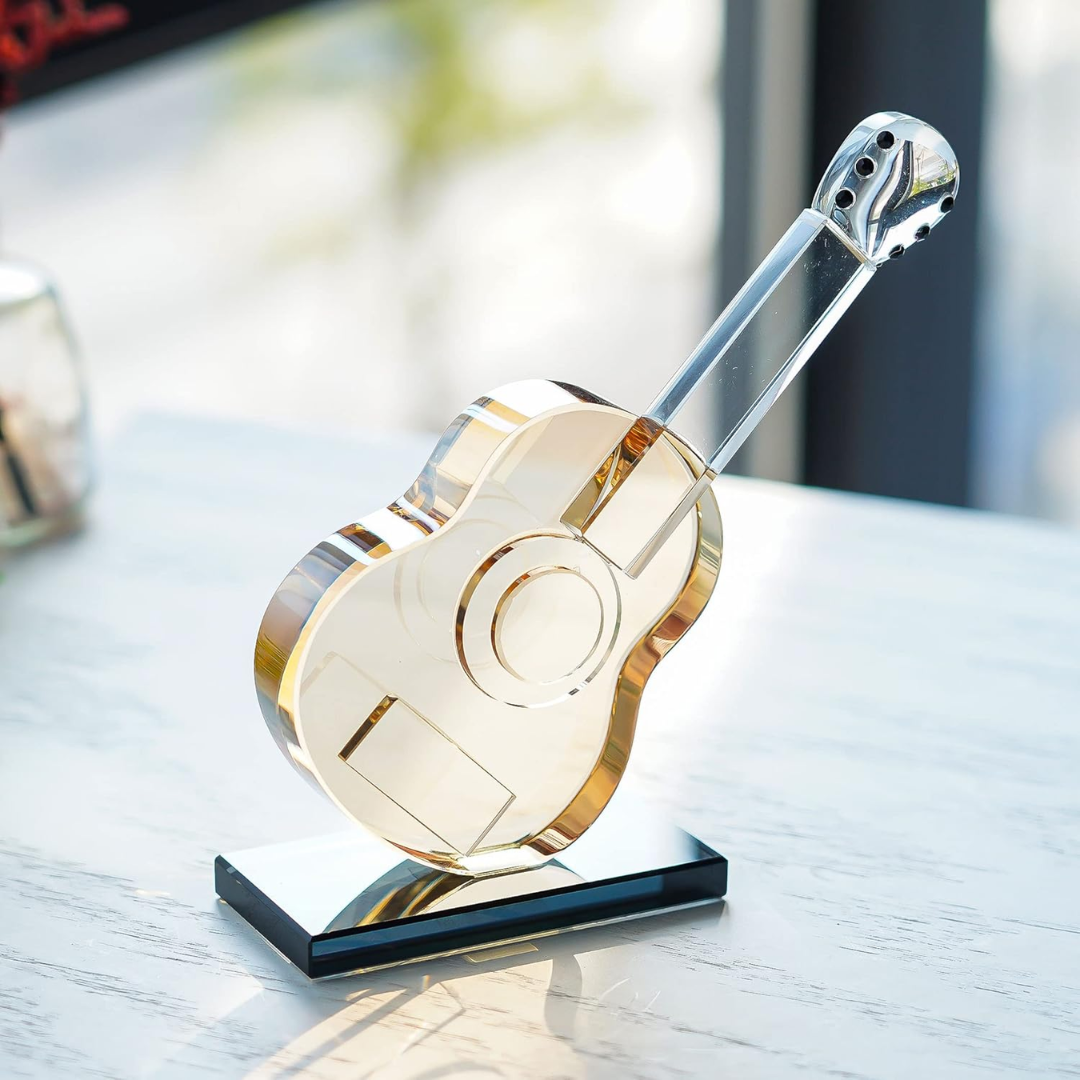 Decorative glass guitar on a stand with a blurred background
