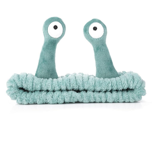 Cute green snail spa headband with plush eye stalks for skincare, makeup and face washing