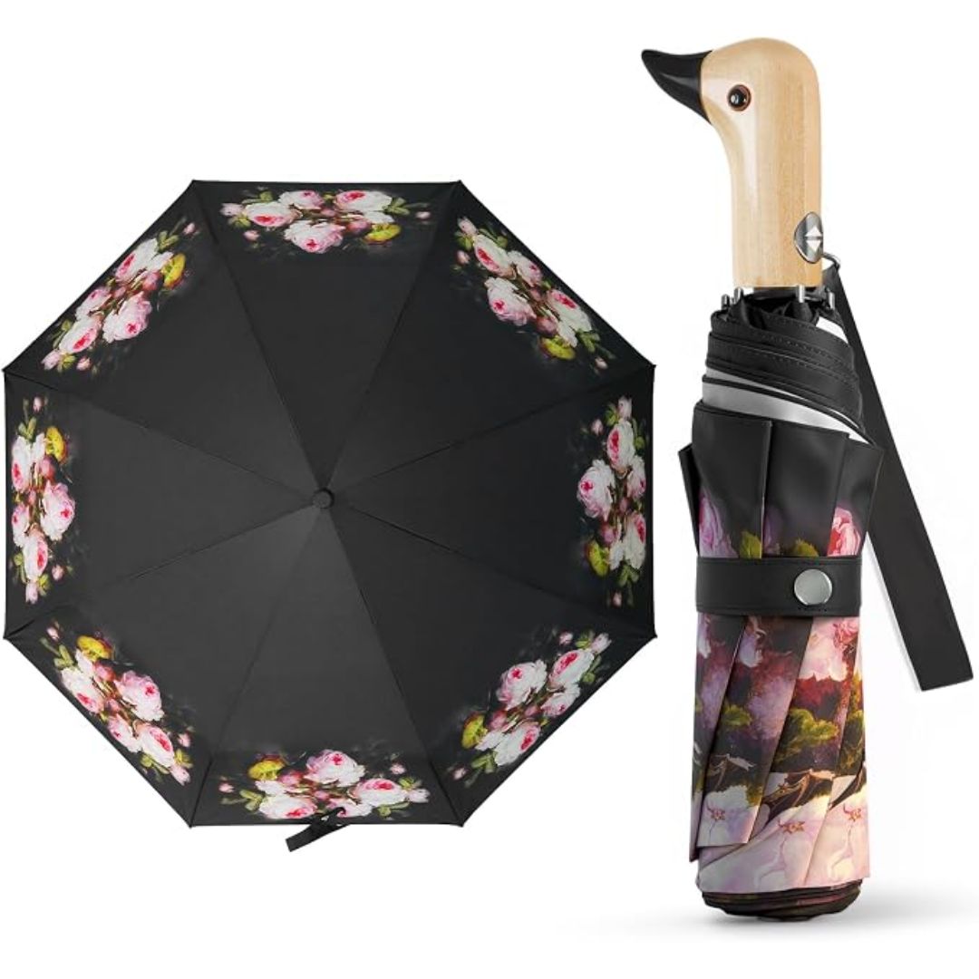 A black umbrella with a pink and green floral pattern, shown open on the left and folded with a duck-shaped wooden handle on the right, against a plain white background.
