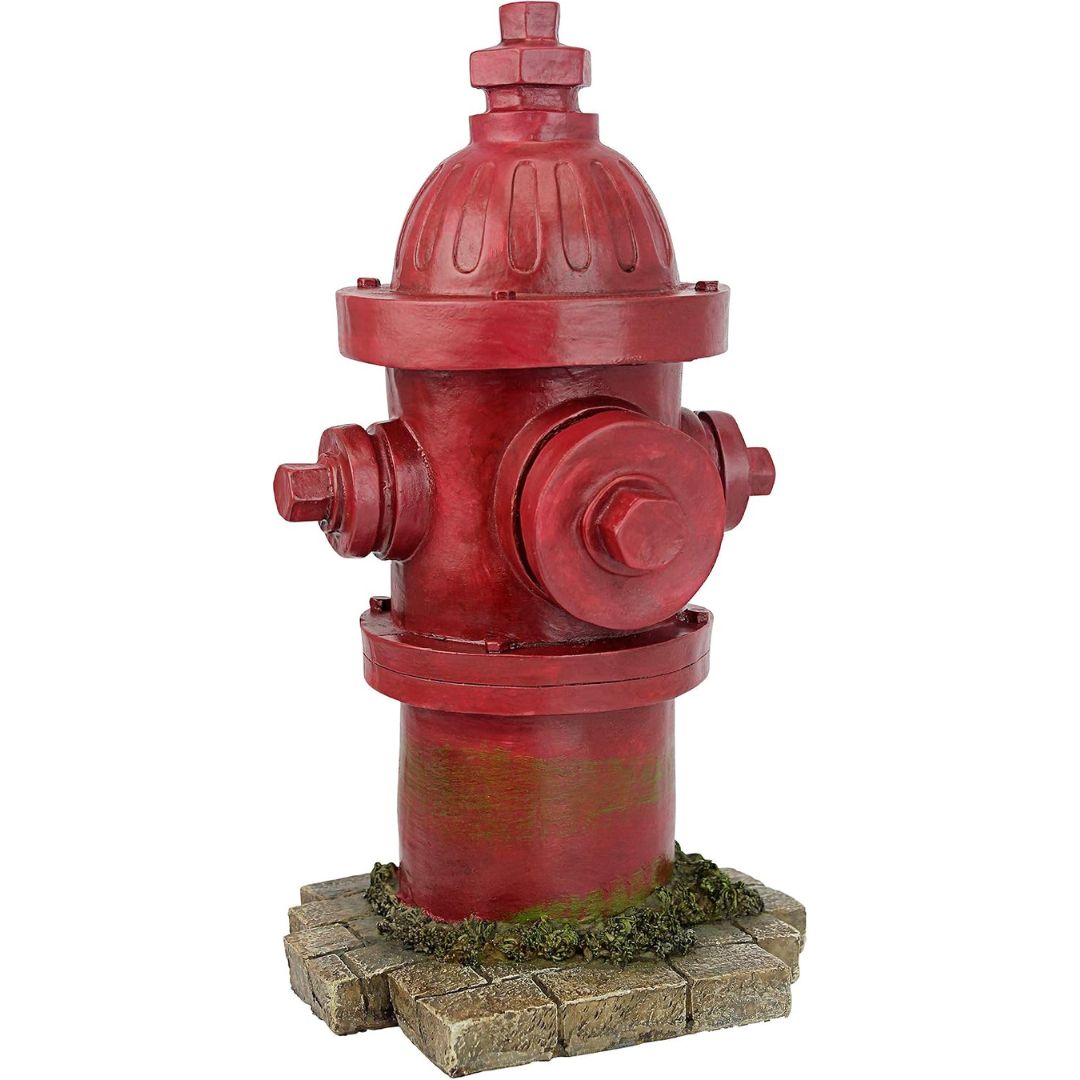A red fire hydrant for dogs with a weathered, distressed finish, mounted on a faux stone and moss base against a plain white background.