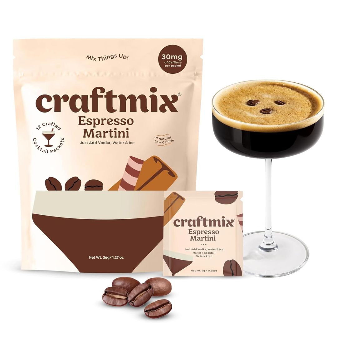Craftmix Espresso Martini mixer packets with a prepared espresso martini cocktail and coffee beans