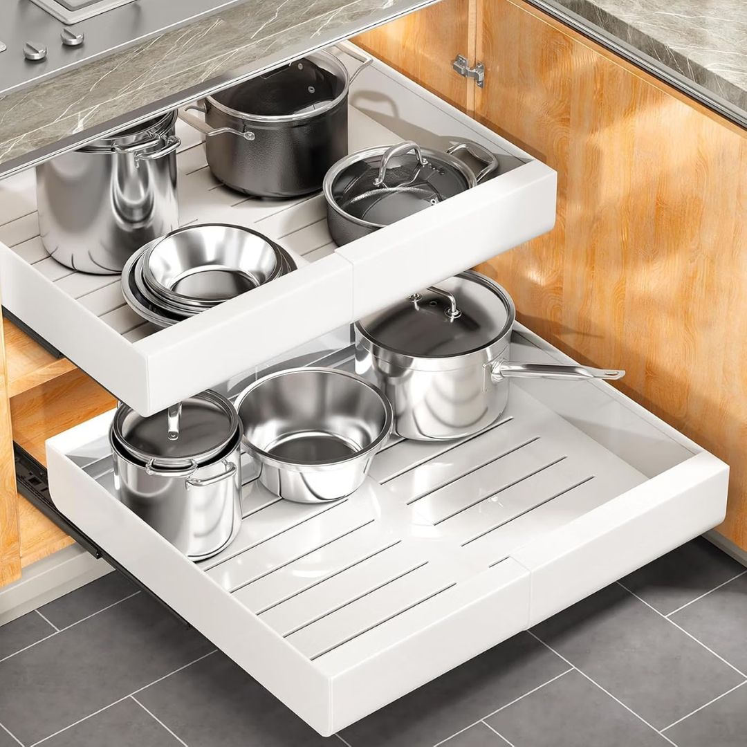 Two white expandable pull out cabinet organizers in a kitchen scenario.