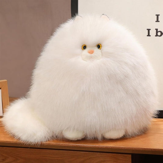 White fluffy toy cat on a wooden surface with a neutral background