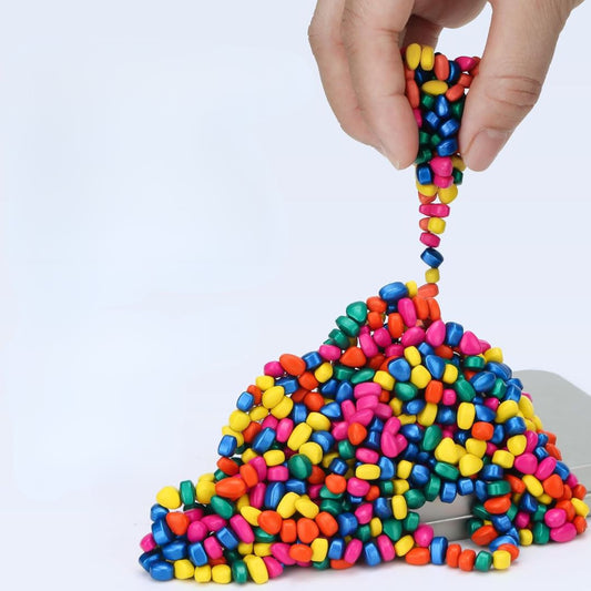Colorful ferrite putty slime being stretched by a hand on a white background