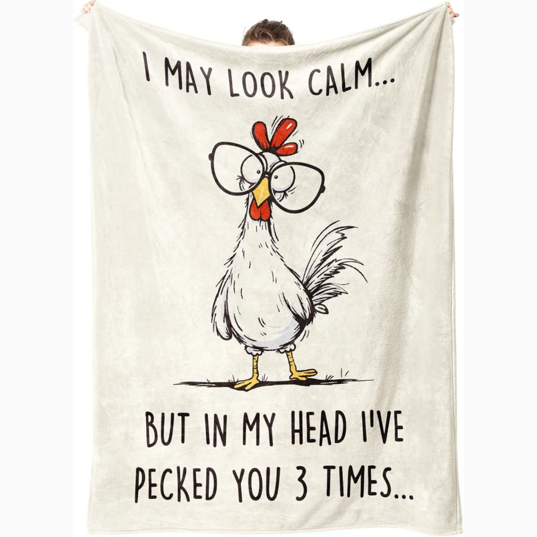 Blanket with a cartoon chicken and humorous text on a white background