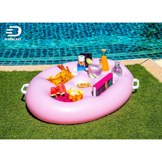Pink inflatable pool table with snacks and drinks by a pool