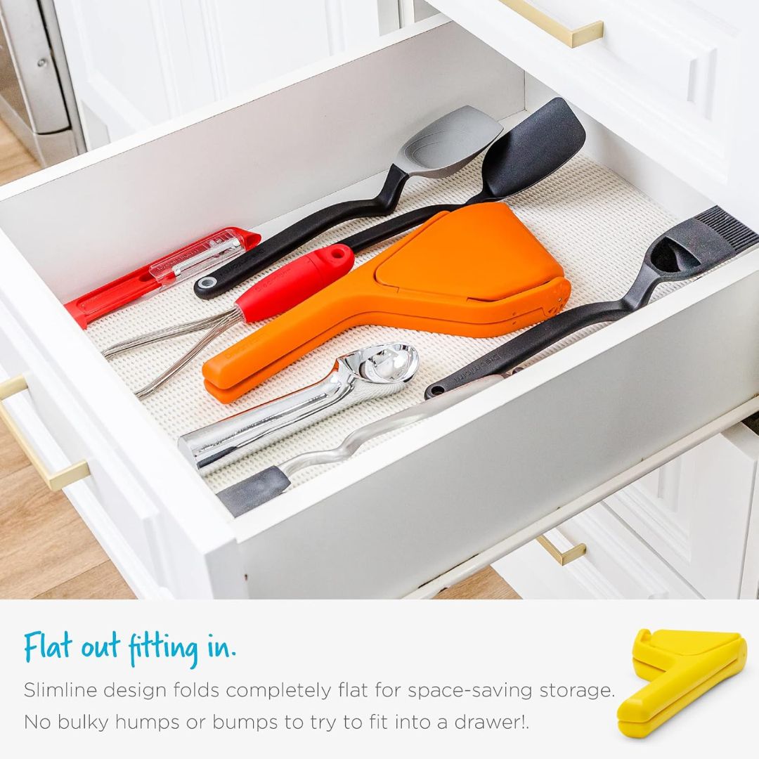 Fold-flat citrus juicer stored neatly in a kitchen drawer alongside other cooking utensils