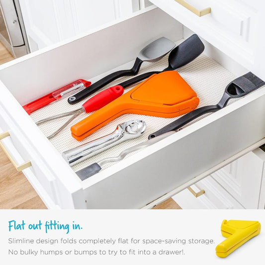 Fold-flat citrus juicer stored neatly in a kitchen drawer alongside other cooking utensils
