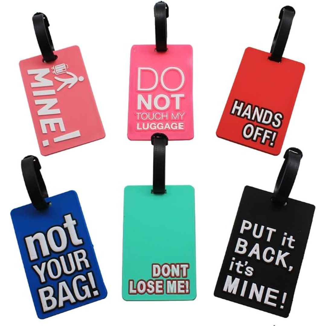 Six colorful luggage tags with black hanging loops, each featuring humorous text such as 'MINE!', 'DO NOT TOUCH MY LUGGAGE', 'HANDS OFF!', 'not YOUR BAG!', 'DONT LOSE ME!', and 'PUT it BACK, it's MINE!' on a plain white background.
