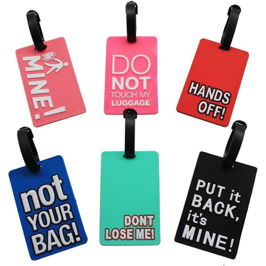 Six colorful luggage tags with black hanging loops, each featuring humorous text such as 'MINE!', 'DO NOT TOUCH MY LUGGAGE', 'HANDS OFF!', 'not YOUR BAG!', 'DONT LOSE ME!', and 'PUT it BACK, it's MINE!' on a plain white background.