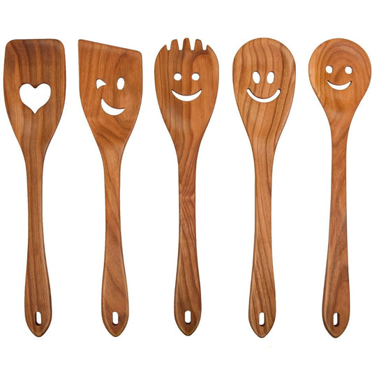 Set of five wooden utensils with smiley face designs on a white background