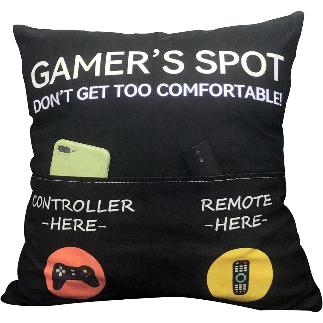 Black pillow with text and pockets labeled 'Controller Here' and 'Remote Here', featuring gaming-themed design.