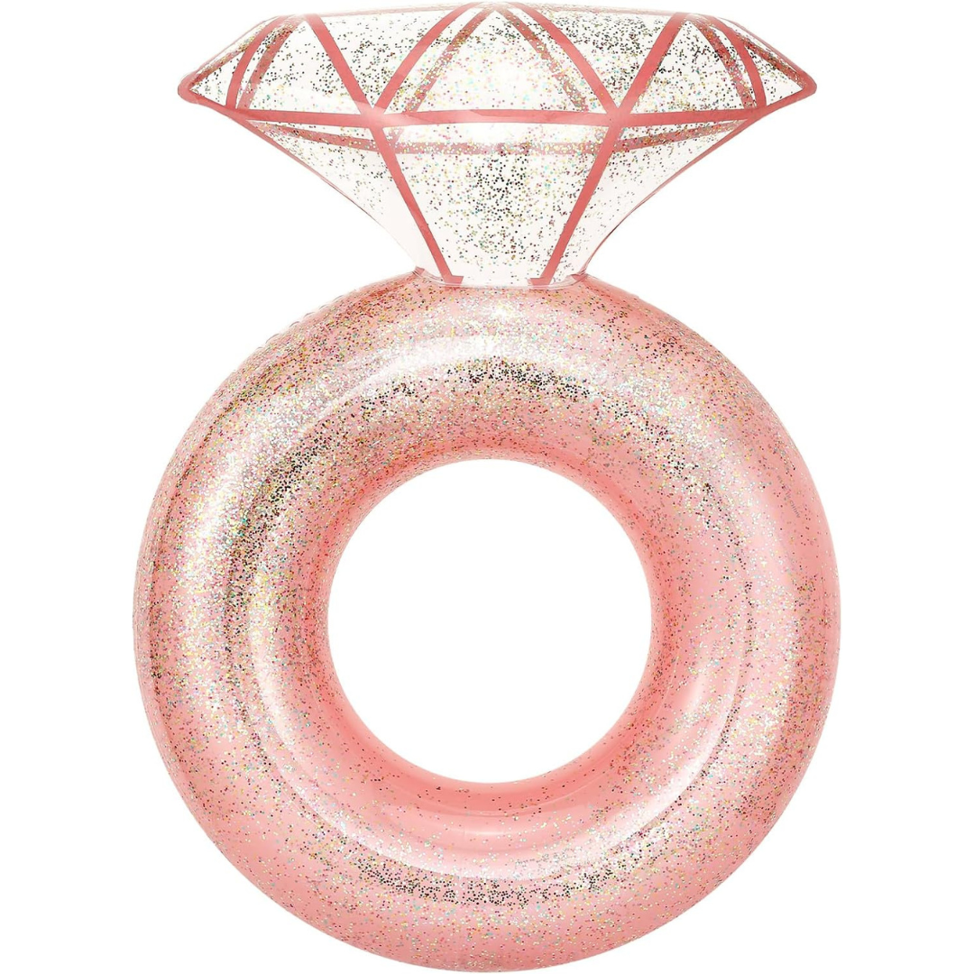 A giant pink inflatable pool float shaped like a diamond ring..