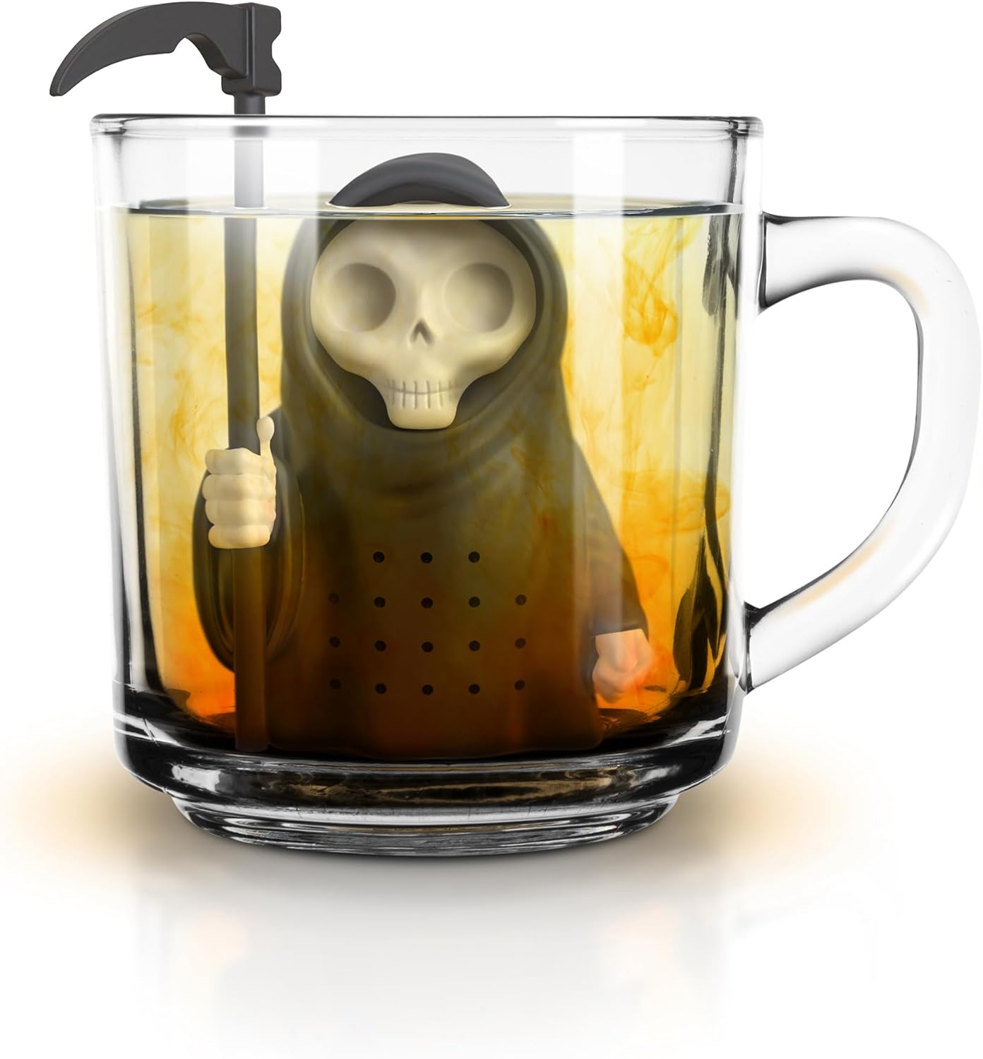 A black silicone Grim Reaper tea infuser with a scythe, steeping in a clear glass mug filled with amber tea, creating a swirling effect.