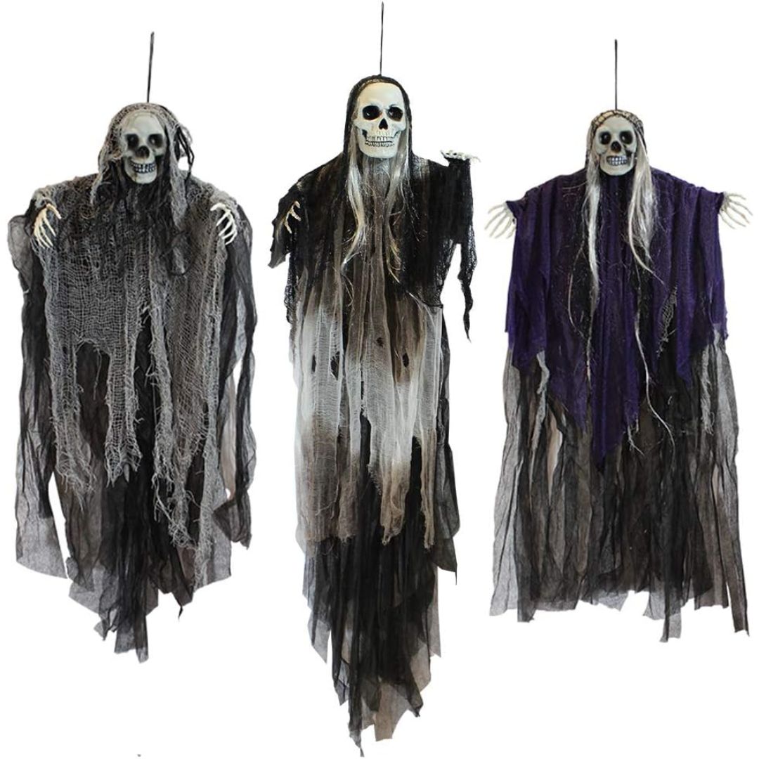 Three hanging Halloween skeleton decorations with tattered black and gray robes, one with a purple robe, shown against a plain white background.