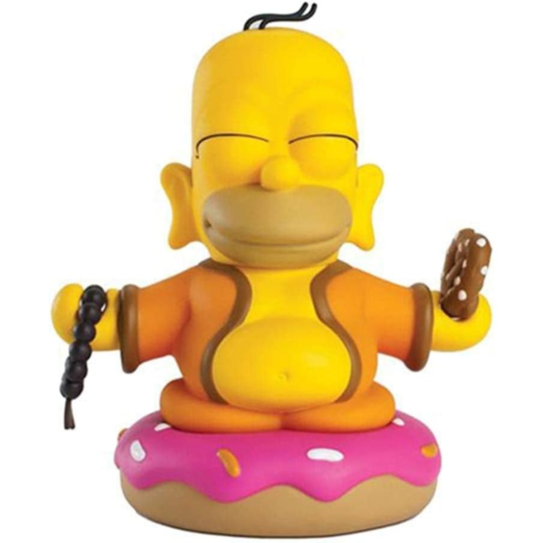 Homer Simpson figurine sitting on a donut in a zen relaxed state on a white background
