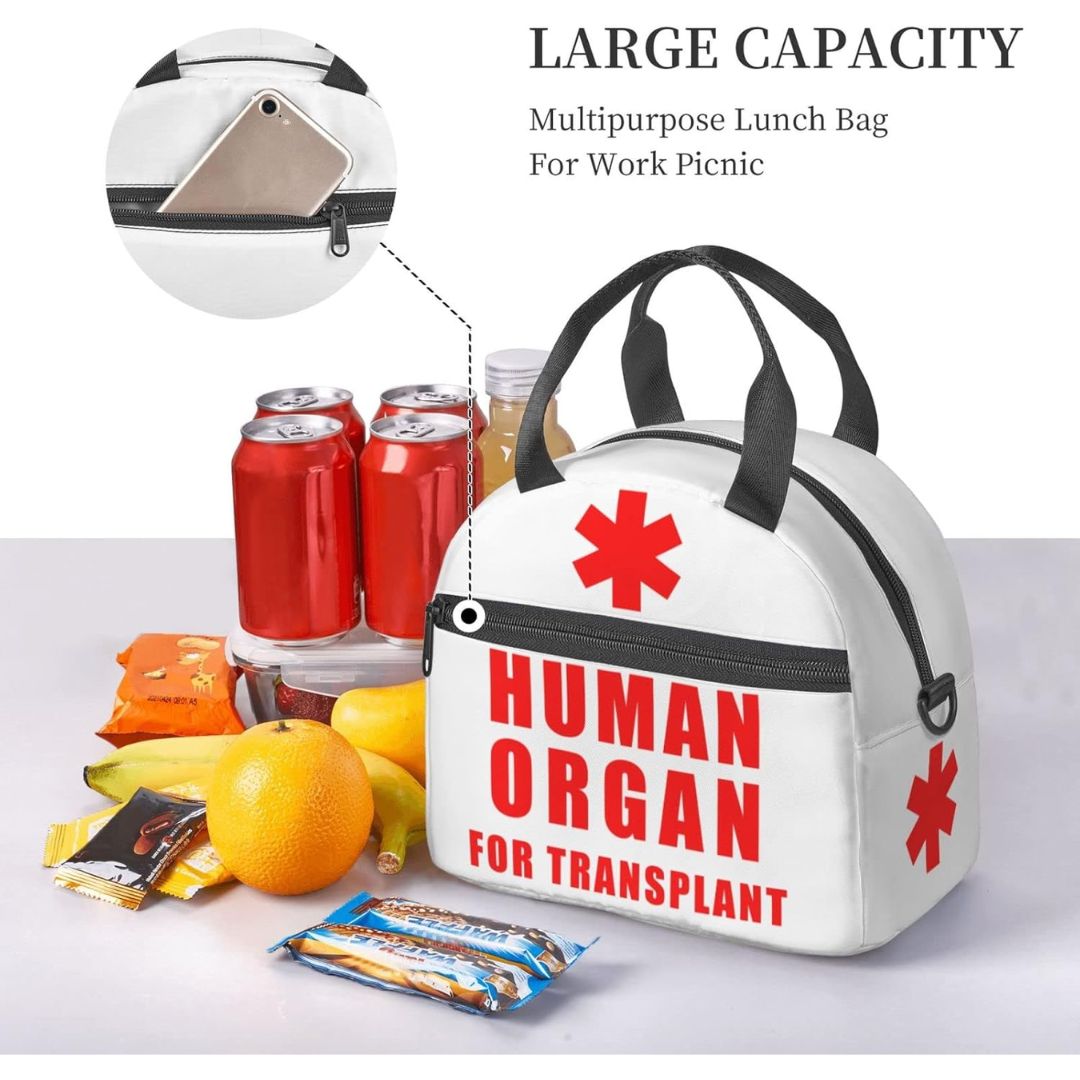 White lunch bag with black handles and zipper trim, printed with a red medical star and the words 'HUMAN ORGAN FOR TRANSPLANT.' The bag is shown with snacks, soda cans, and a bottle, with text reading 'LARGE CAPACITY' and 'Multipurpose Lunch Bag For Work Picnic.