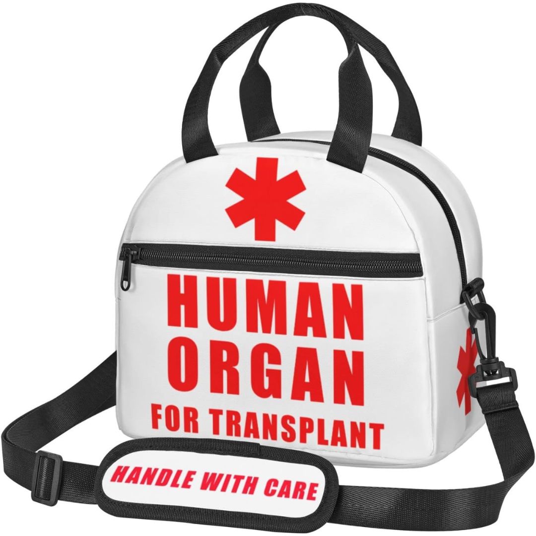 White insulated lunch bag with black handles and strap, featuring a red medical star and the text 'HUMAN ORGAN FOR TRANSPLANT' on the front, plus a matching 'HANDLE WITH CARE' patch on the strap.