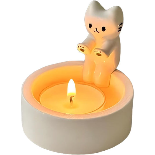 Cat-shaped candle holder with a lit candle on a white background