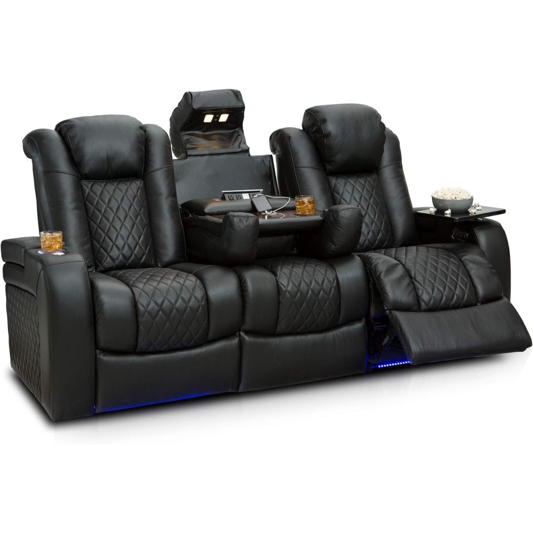 Black leather home theater recliner sofa with two extended seats, quilted diamond-patterned upholstery, built-in headrest screens, built-in side tables with trays, and blue LED underglow, shown on a white background.