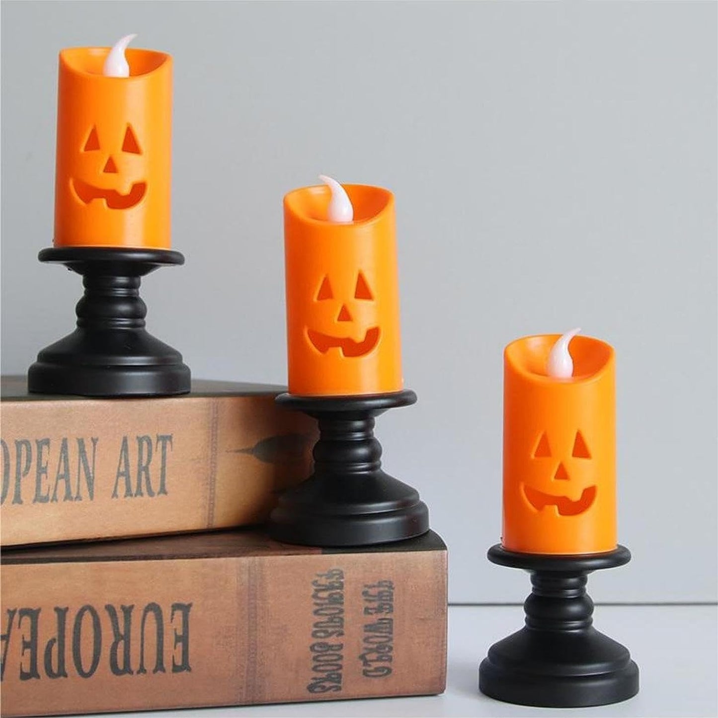 Create a spine-chilling ambiance with these spooktacular ghost-face candles.