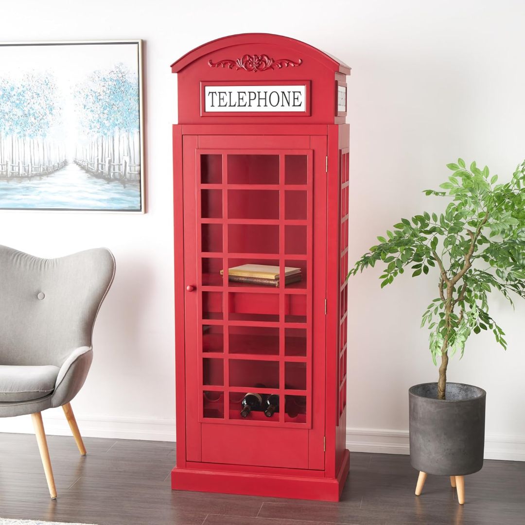 Vintage red telephone booth wine cabinet displayed in a living room with shelving, drawer and bottle storage