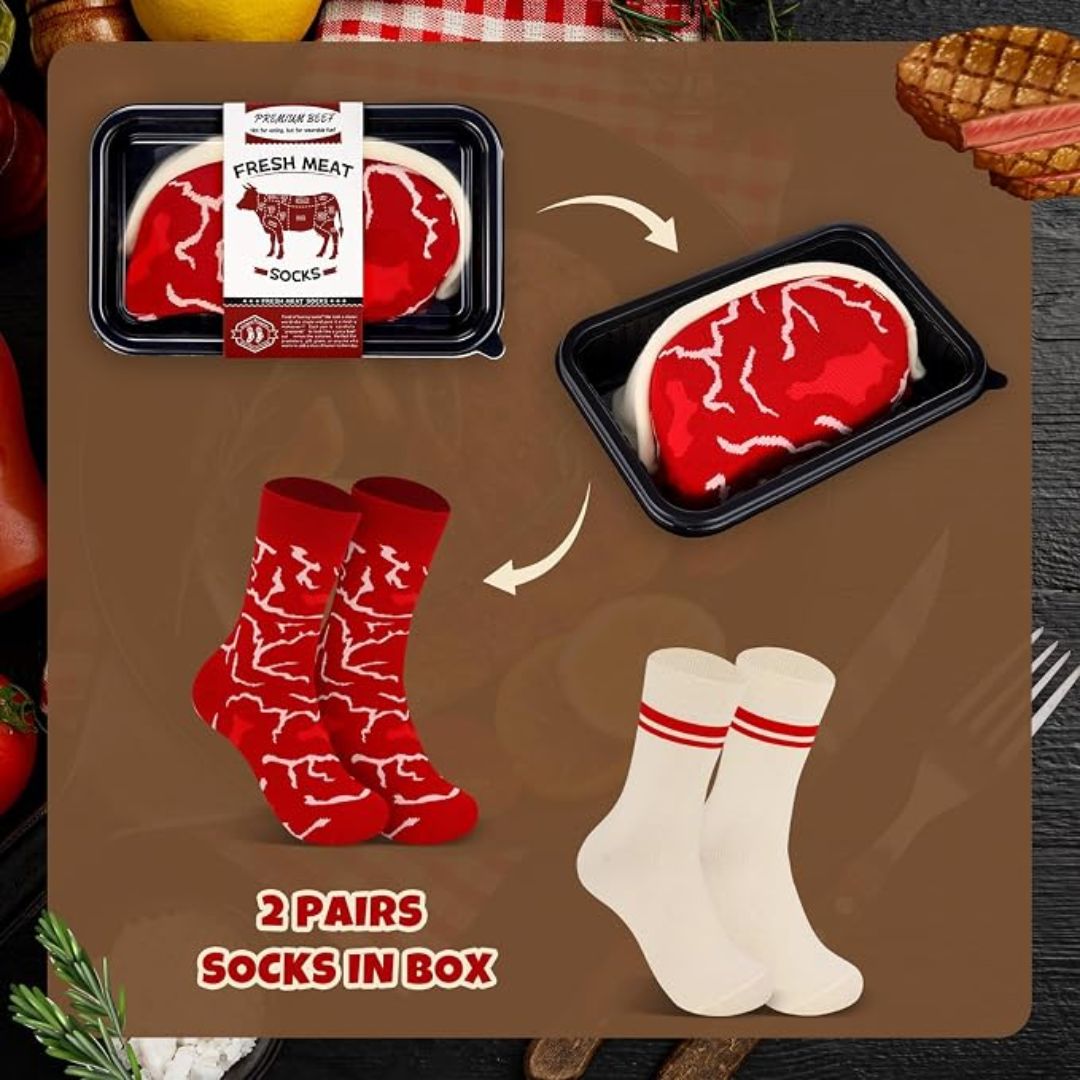 A product listing graphic showing a novelty meat-themed gift set: a packaged fake fresh meat package labeled 'FRESH MEAT SOCKS' and two pairs of socks, one pair red with white meat-like markings and one pair white with red stripes. Arrows indicate the set contents, with text reading '2 Pairs Socks in Box.