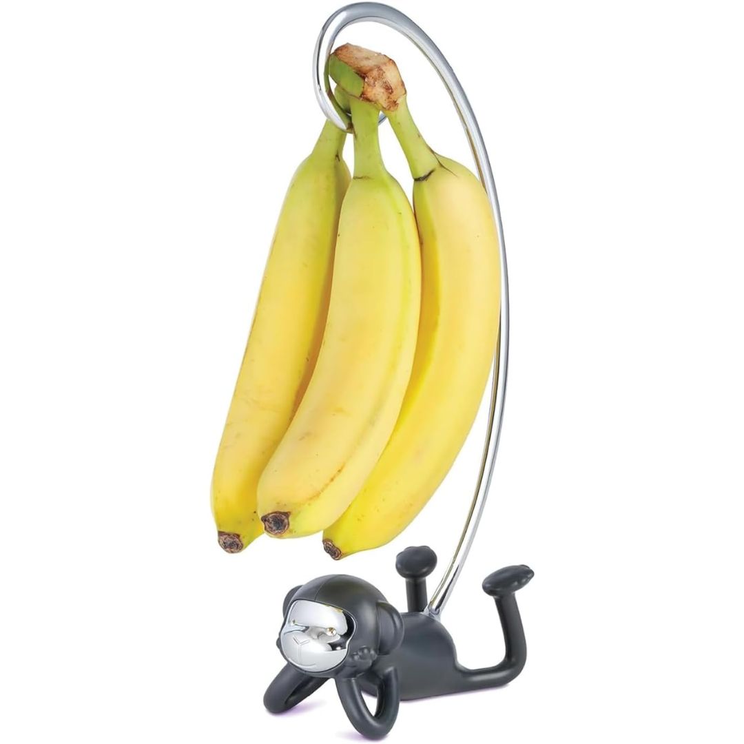 Monkey shaped kitchen banana holder with bananas hanging above it