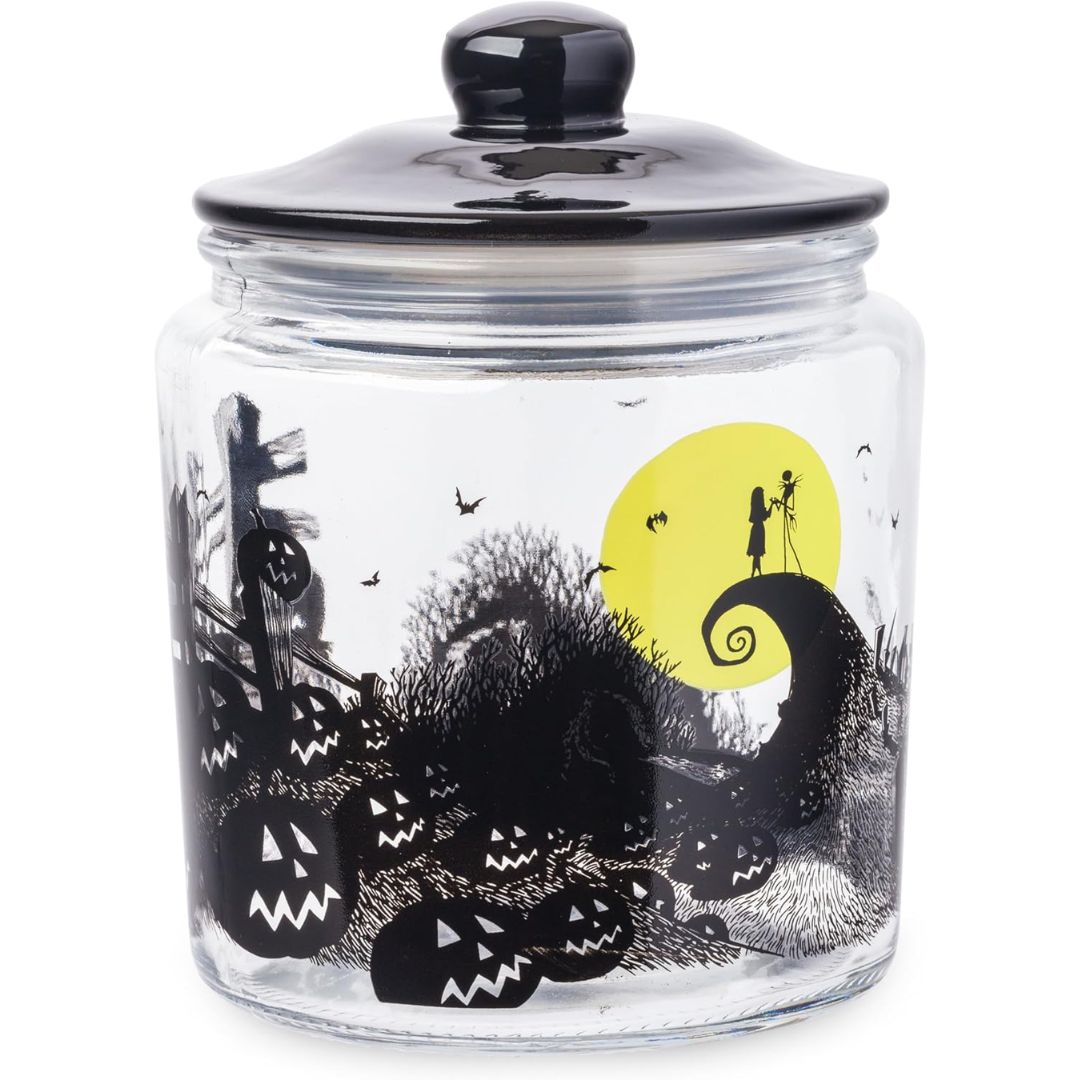 The Nightmare Before Christmas glass candy jar with a black lid, pumpkins and Jack and Sally silhouetted against a yellow moon.