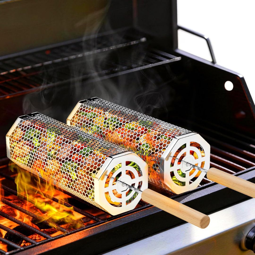 Two metal octagonal skewer grill baskets filled with colorful vegetables, cooking over an open flame on a grill with smoke rising.