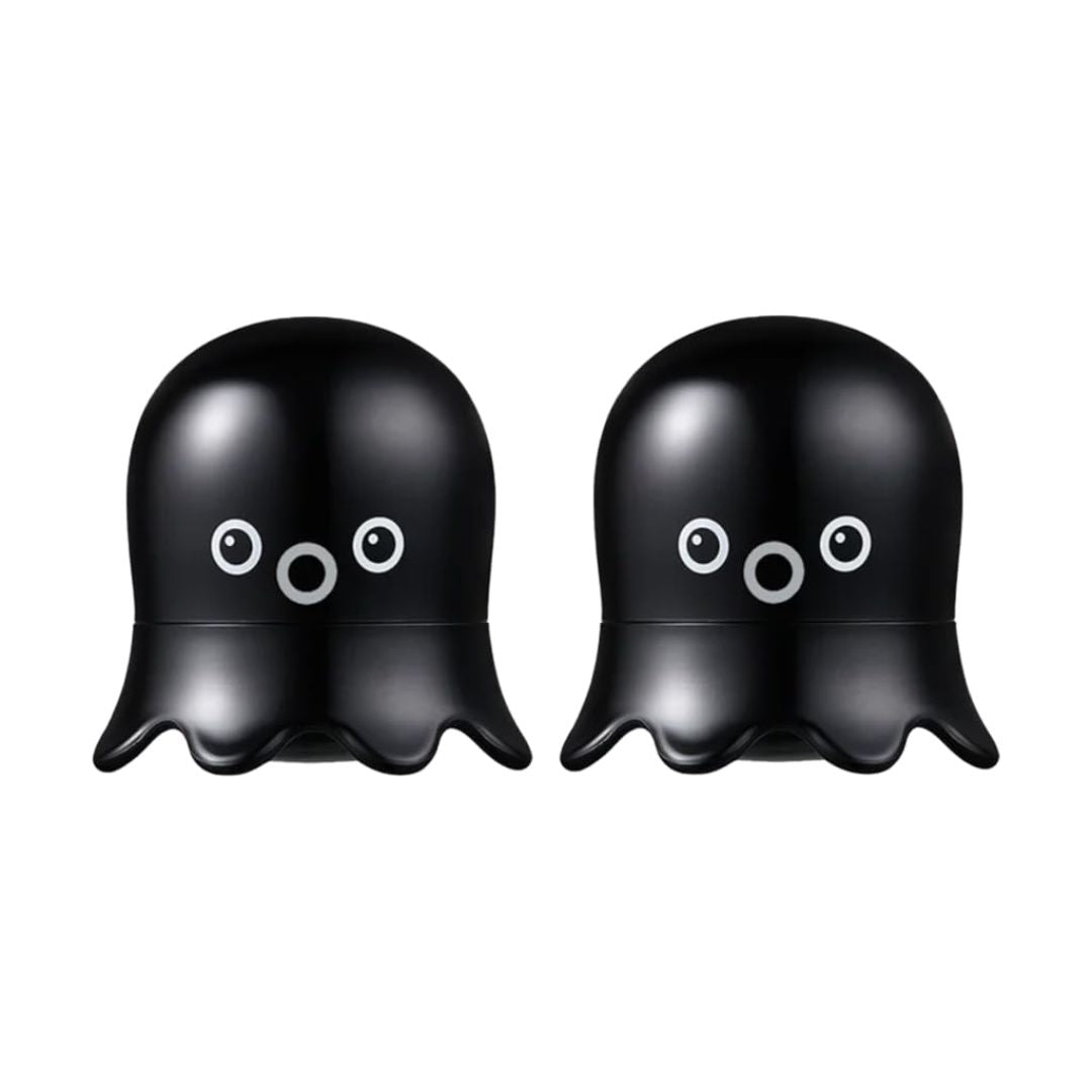 Two black octopus-shaped blackhead scrub stick with cute white and gray cartoon eyes, shown side by side on a plain white background.