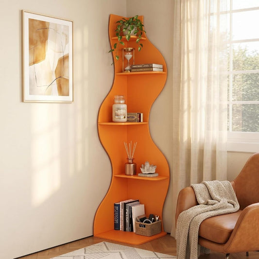 Orange wavy 5-tier corner bookshelf styled with books, plant, candle and decor beside a window and armchair